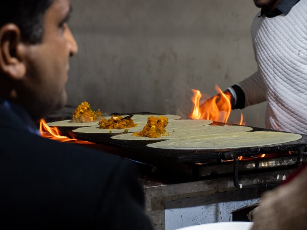 Live cooking counter with flames at wedding catering event Dehradun
