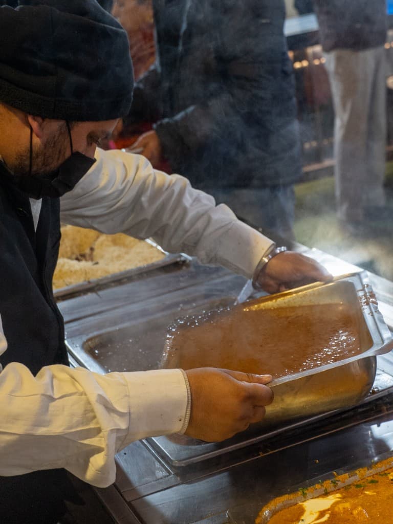 Catering staff managing chafing dishes at wedding buffet